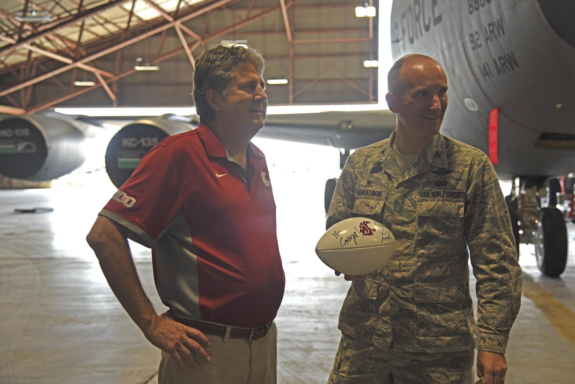 Col. Ryan Samuelson, 92nd Air Refueling Wing commander provides Mike Leach, Washington State University head football coach, a mission briefing during his visit Aug. 15, 2017, at Fairchild Air Force Base, Washington. Leach’s father, Frank, served in the Air Force during the Korean War. He was stationed at Deep Creek, one of four storage facilities near present-day Fairchild used for Nike missiles during the 1950s and 1960s. (U.S. Air Force photo/Senior Airman Mackenzie Richardson)
