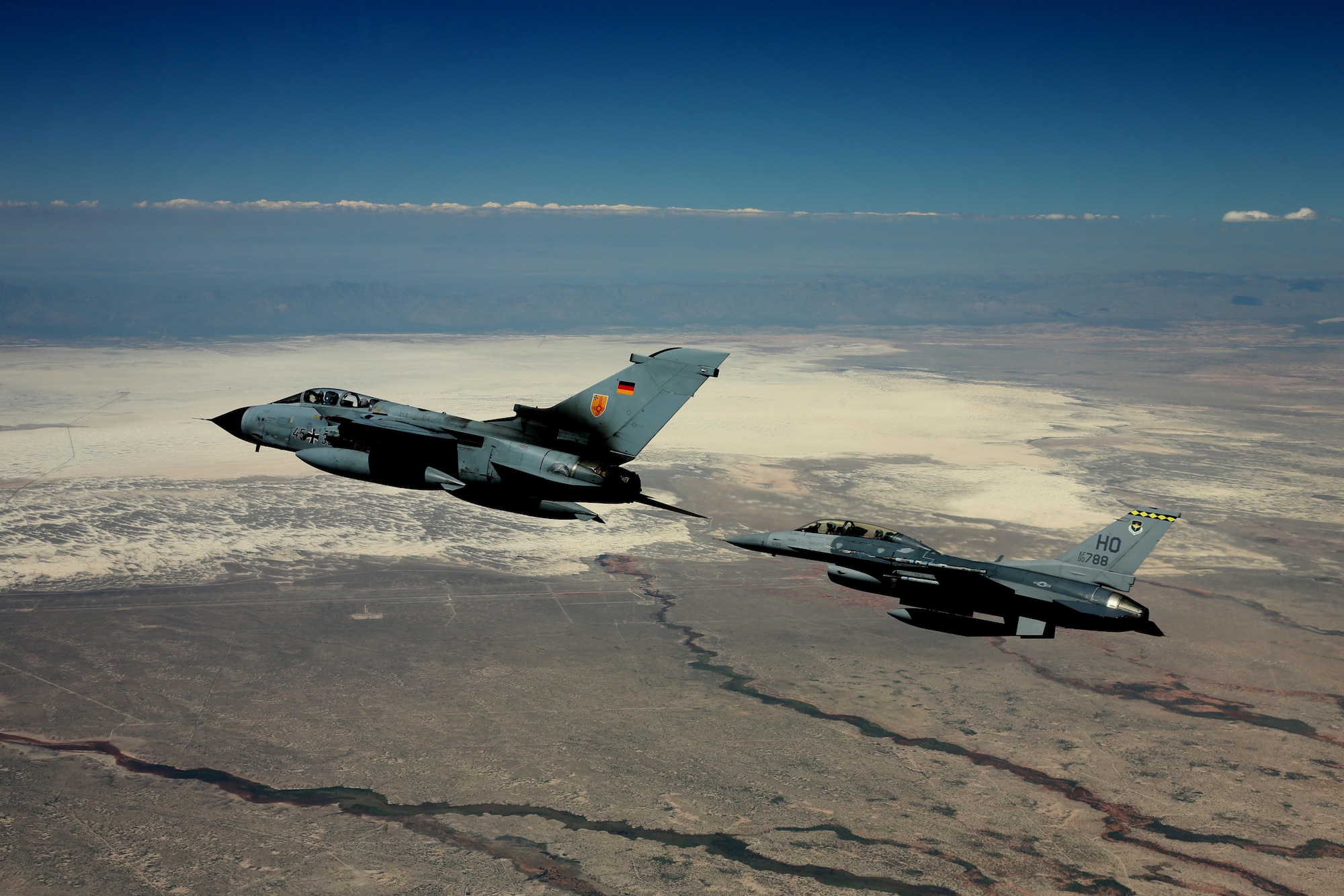 A German air force Tornado and an F-16 Fighting Falcon assigned to the 314th Fighter Squadron fly in formation together during the last joint flying mission at Holloman Air Force Base, Aug. 17, 2017. The GAF has entered its final stage of departure, however they will not complete their departure from Holloman AFB until mid 2019. (U.S. Air Force photo by Maj. Bradford "Emcon" Brizek)