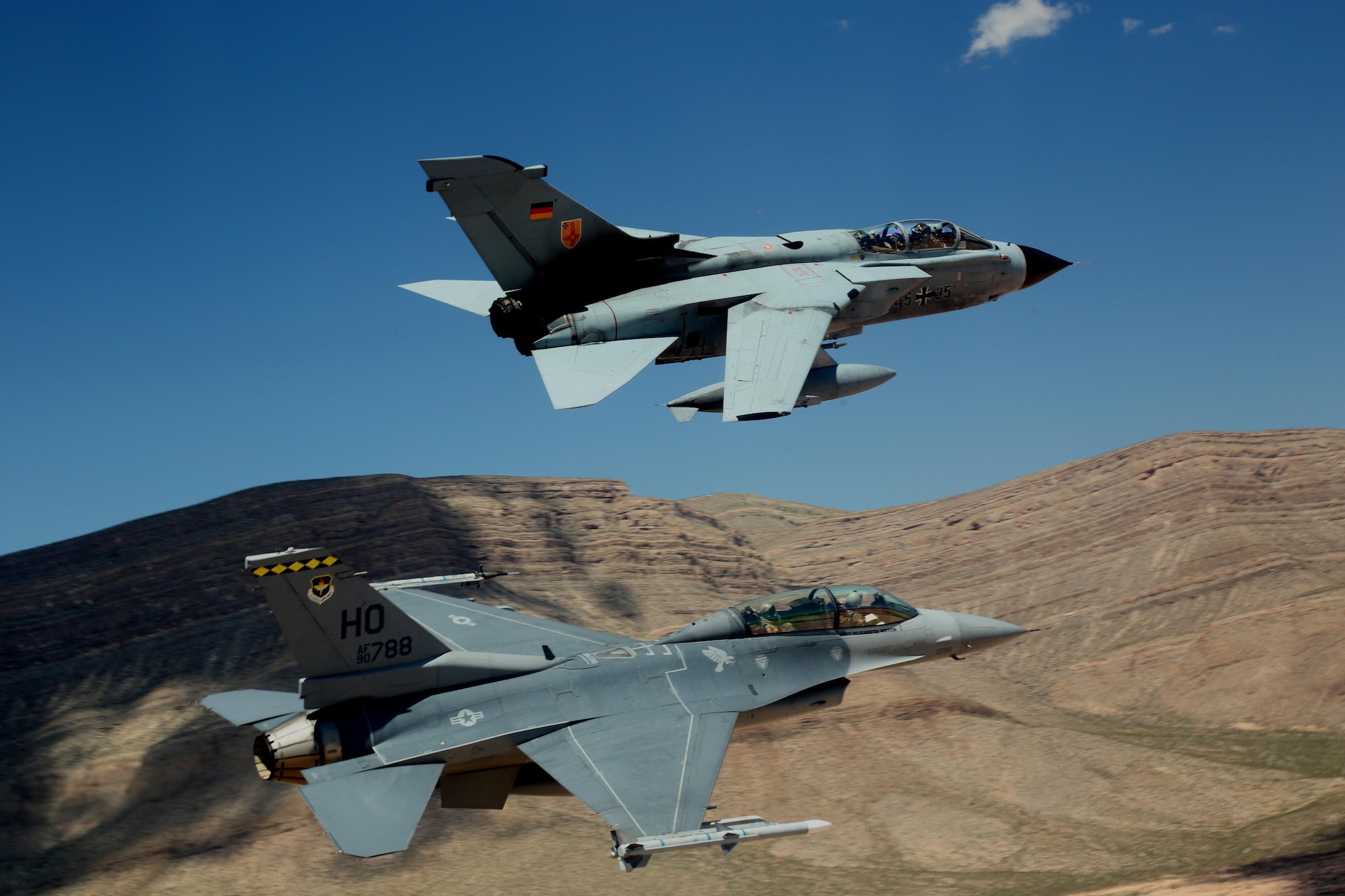 A German air force Tornado and an F-16 Fighting Falcon assigned to the 314th Fighter Squadron fly in formation together during the last joint flying mission at Holloman Air Force Base, Aug. 17, 2017. The GAF has entered its final stage of departure, however they will not complete their departure from Holloman AFB until mid 2019. (U.S. Air Force photo by Maj. Bradford "Emcon" Brizek)