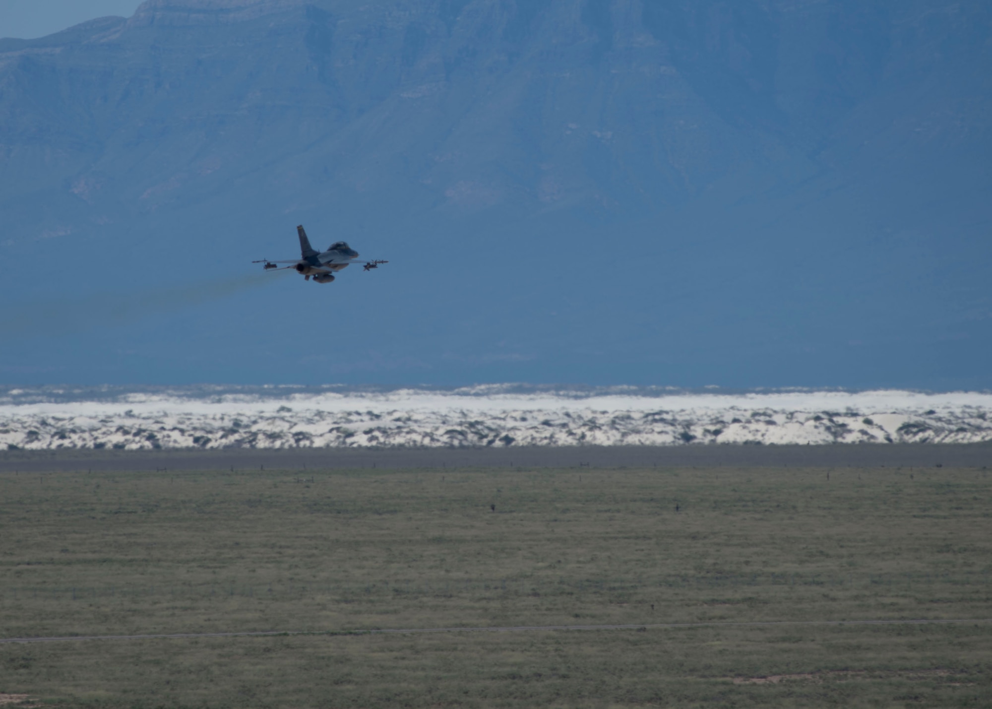 An F-16 Fighting Falcon assigned to the 314th Fighter Squadron flies toward White Sands National Monument as part of the last joint flying mission with a German air force Tornado at Holloman Air Force Base, N.M., Aug. 17, 2017. The German Air Force has entered its final stage of departure, however they will not complete their departure from Holloman AFB until mid 2019. (U.S. Air Force photo by Senior Airman Chase Cannon)