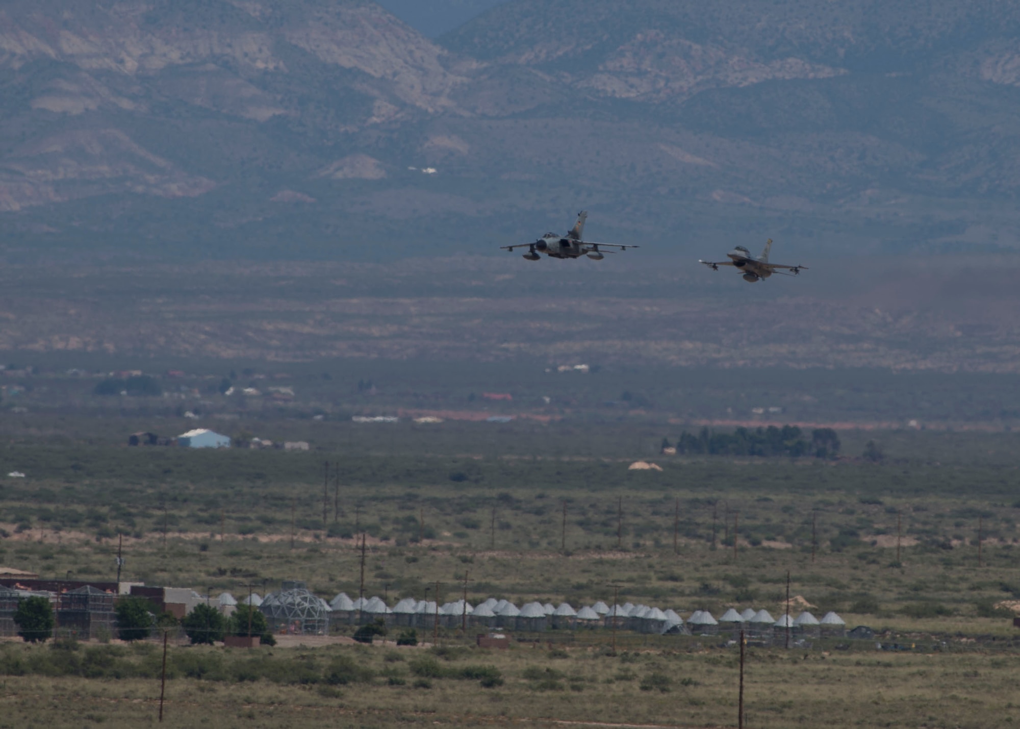 A German air force Tornado aircraft and an F-16 Fighting Falcon perform their last flight together with senior leaders from their respective commands at Holloman Air Force Base, N.M., Aug. 17, 2017. The German air force has entered its final stage of departure, however they will not complete their departure from Holloman AFB until mid 2019. (U.S. Air Force photo by Senior Airman Chase Cannon)