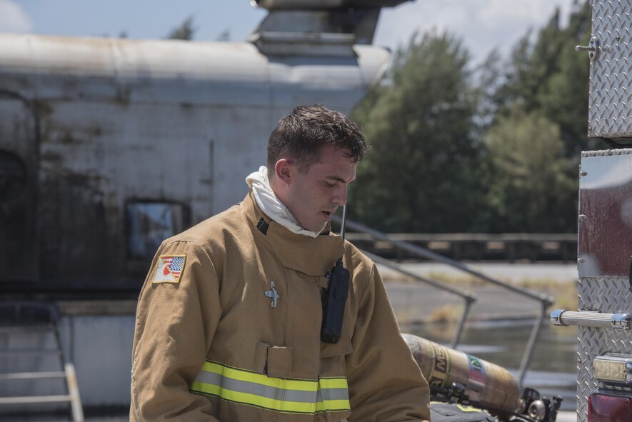 U.S. Air Force Senior Airman Keith Brown, 18th Civil Engineer Squadron firefighter, takes off his gear after annual hands-on fire training August 14, 2017, at Kadena Air Base, Japan. Okinawan firefighters conduct live fire training annually with 18th CES firefighters to help maintain readiness for Team Kadena and Okinawa in case of emergencies. (U.S. Air Force photo/ Airman 1st Class Greg Erwin)