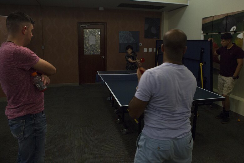 MCAS FUTENMA, OKINAWA, Japan— A local student plays ping pong with a Marine during the 6th Marine Corps Air Station Futenma English Discussion class party Aug. 15 at the United Service Organization building on MCAS Futenma, Okinawa, Japan.