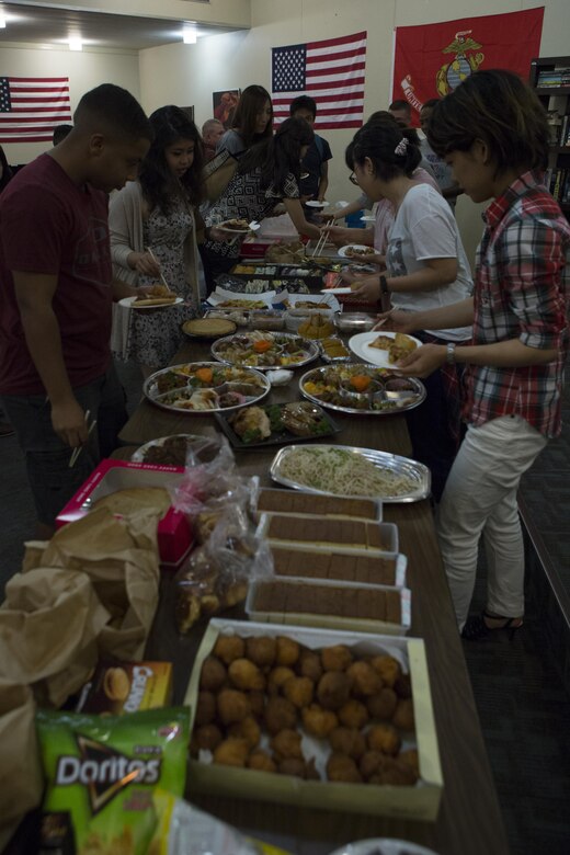 MCAS FUTENMA, OKINAWA, Japan— Local students and Marines get food during the 6th Marine Corps Air Station Futenma English Discussion class party Aug. 15 at the United Service Organization building on MCAS Futenma, Okinawa, Japan.