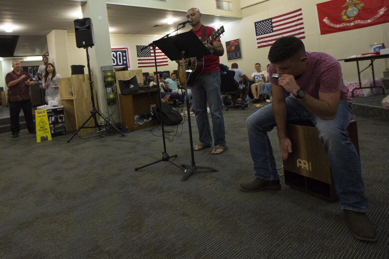 MCAS FUTENMA, OKINAWA, Japan— Lance Cpl. Christopher Montalvo, left, and Lance Cpl. Ryan Glover perform during the 6th Marine Corps Air Station Futenma English Discussion class party Aug. 15 at the United Service Organization building on MCAS Futenma, Okinawa, Japan.