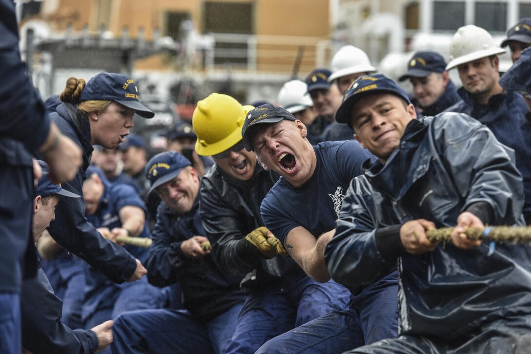 Members of two Coast Guard teams play a tug-of-war.