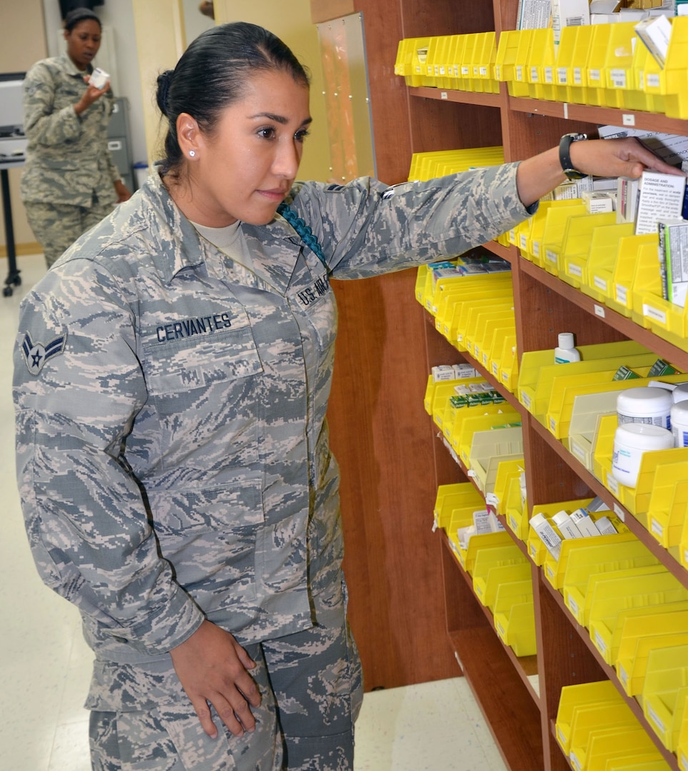 Airman 1st Class Amanda Cervantes, a student in the Medical Education and Training Campus Pharmacy Technician program on Joint Base San Antonio-Fort Sam Houston, examines medication while training in the simulated outpatient pharmacy laboratory. The simulated laboratory provides students with hands-on training  and practical experience as they would in a real pharmacy setting.  Cervantes, a widow with four children, joined the Air Force Reserve to set an example for her children, serve her country, and work in the medical field so she can help people.