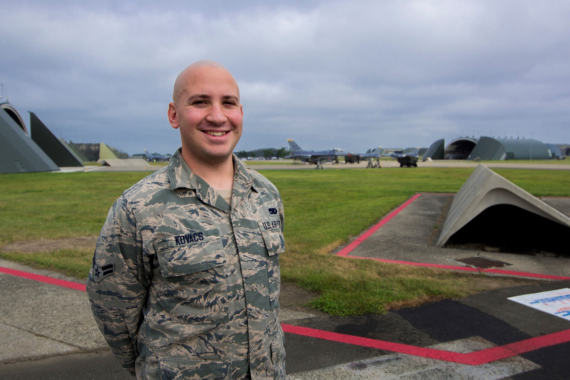 U.S. Air Force Airman 1st Class Anthony Kovacs, Jr., a 14th Fighter Squadron crew chief, poses on the tarmac at Misawa Air Base, Japan.