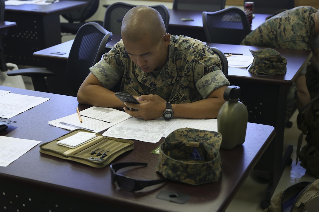 Lance Cpl. Michael Li calculates his monthly spending