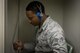Senior Airman Alphonso Carter, 374th Public Health technician, prepares to perform a hearing test, Aug. 7, 2017, at Yokota Air Base, Japan. The Airman being tested is equipped with headphones and a button to click each time they hear a beep while they are in a special sound proof chamber. (U.S. Air Force photo by Airman 1st Class Donald Hudson)