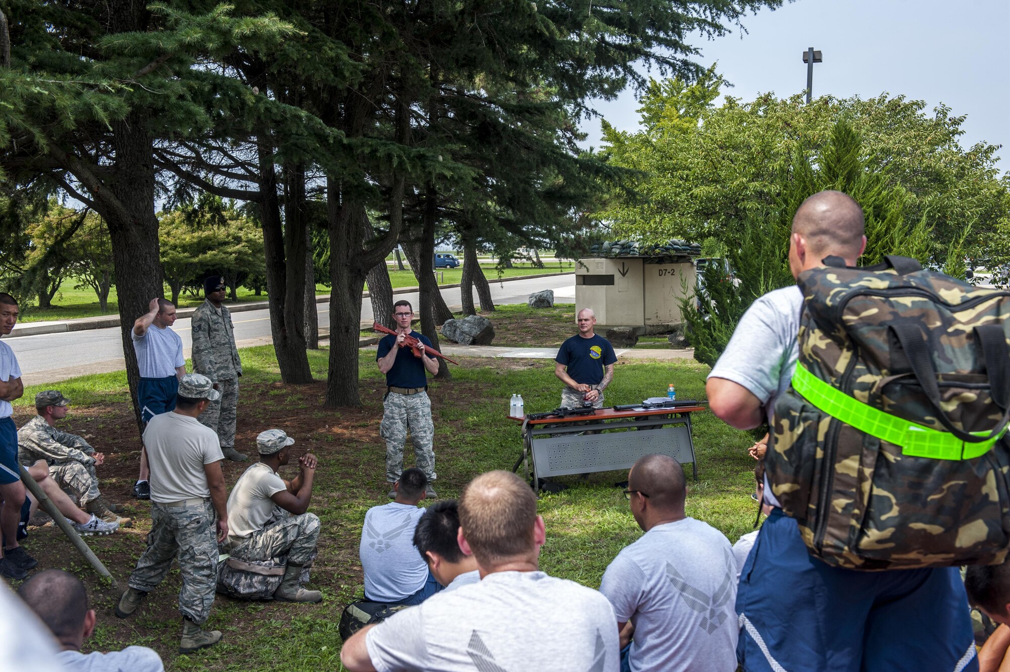 U.S. Air Force Airmen assigned to the 8th Fighter Wing, learn how to properly handle the M-4 carbine rifle during a wing training day that focused on the Ability to Survive and Operate at Kunsan Air Base, Republic of Korea, Aug. 18, 2017. During the event, Airmen were placed in smaller groups so that everyone would have the chance to ask questions and have confidence in their ability to implement the skills that were taught. (U.S. Air Force photo by Senior Airman Colville McFee)