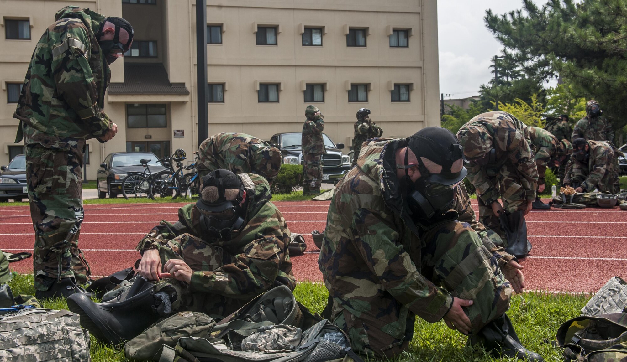 U.S. Air Force Airmen assigned to the 8th Fighter Wing, practice donning protective Mission Oriented Protective Posture gear during a wing training day at Kunsan Air Base, Republic of Korea, Aug. 18, 2017. The day focused on Ability To Survive and Operate training, self-defense and Self Aid Buddy Care. (U.S. Air Force photo by Senior Airman Colville McFee)
