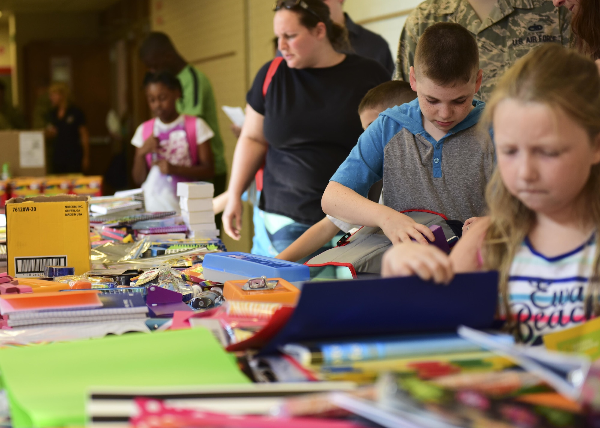 Parents help their children select school supplies during the Back-to-School Brigade event at Whiteman Air Force Base, Mo., Aug. 8, 2017. The event was hosted at the Whiteman Elementary School and was open to all active duty, Air National Guardsmen and reservist with children in grades kindergarten through 12th. (U.S. Air Force photo by Staff Sgt. Danielle Quilla)