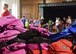 A stack of backpacks wait to be chosen by students during the Back-to-School Brigade event at Whiteman Air Force Base, Mo., Aug. 8, 2017. A total of 300 backpacks and $2,700 worth of supplies were donated to help students start the new school year right. (U.S. Air Force photo by Staff Sgt. Danielle Quilla)