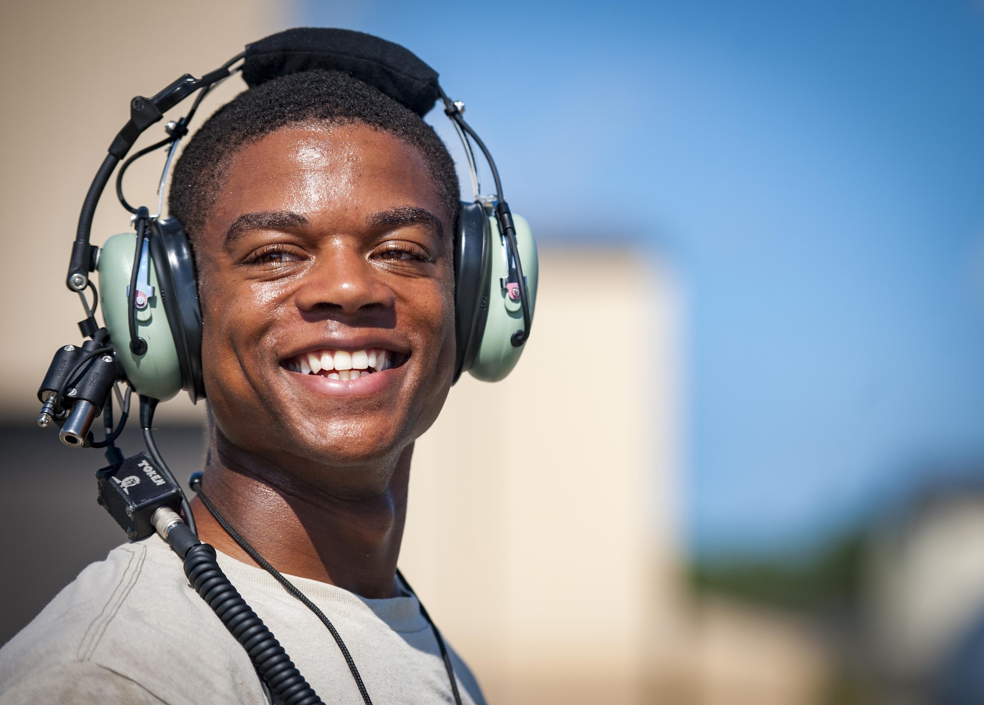 Senior Airman Tavaris Scott, 71st Rescue Squadron Aircraft Maintenance Unit crew chief, smiles as he prepares to launch an HC-130J Combat King II, Aug. 17, 2017, at Moody Air Force Base, Ga. Maintainers perform various tasks prior to take-off such as pre-flight inspections, removing plugs and covers, repairing any problems found during crew pre-flight checks and marshalling the aircraft. (U.S. Air Force photo by Airman 1st Class Lauren M. Sprunk)