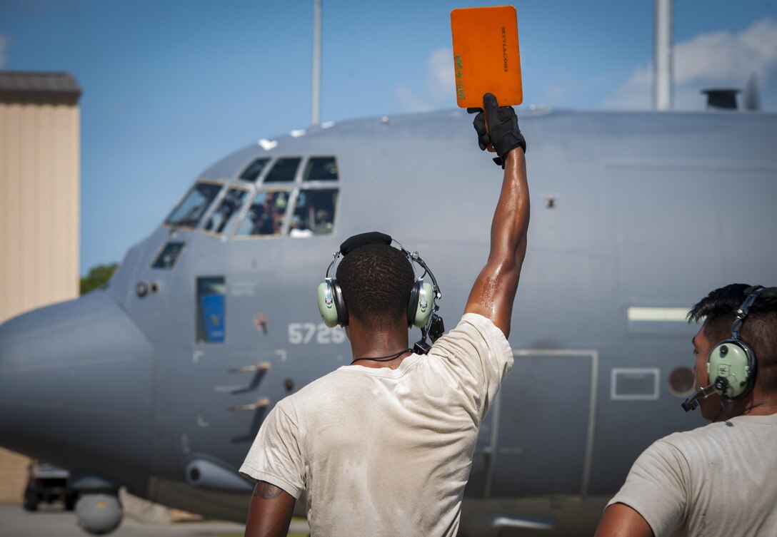 Senior Airman Tavaris Scott, 71st Rescue Squadron Aircraft Maintenance Unit crew chief, marshals an HC-130J Combat King II, Aug. 17, 2017, at Moody Air Force Base, Ga. Maintainers perform various tasks prior to take-off such as pre-flight inspections, removing plugs and covers, repairing any problems found during crew pre-flight checks and marshalling the aircraft. (U.S. Air Force photo by Airman 1st Class Lauren M. Sprunk)