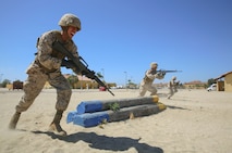 Recruits from Charlie Company, 1st Recruit Training Battalion, run to the next obstacle during the Bayonet Assault Course at Marine Corps Recruit Depot San Diego, Aug. 8.