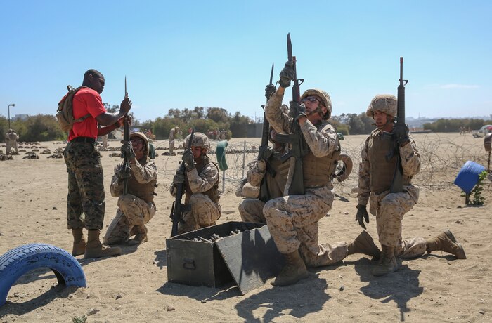 Recruits from Charlie Company, 1st Recruit Training Battalion, attach bayonets to their rifles during the Bayonet Assault Course at Marine Corps Recruit Depot San Diego, Aug. 8.