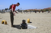A drill instructor from Charlie Company, 1st Recruit Training Battalion, instructs a recruit to move faster during the Bayonet Assault Course at Marine Corps Recruit Depot San Diego, Aug. 8.