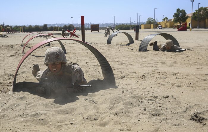Recruits from Charlie Company, 1st Recruit Training Battalion, crawl through tunnels during the Bayonet Assault Course at Marine Corps Recruit Depot San Diego, Aug. 8.