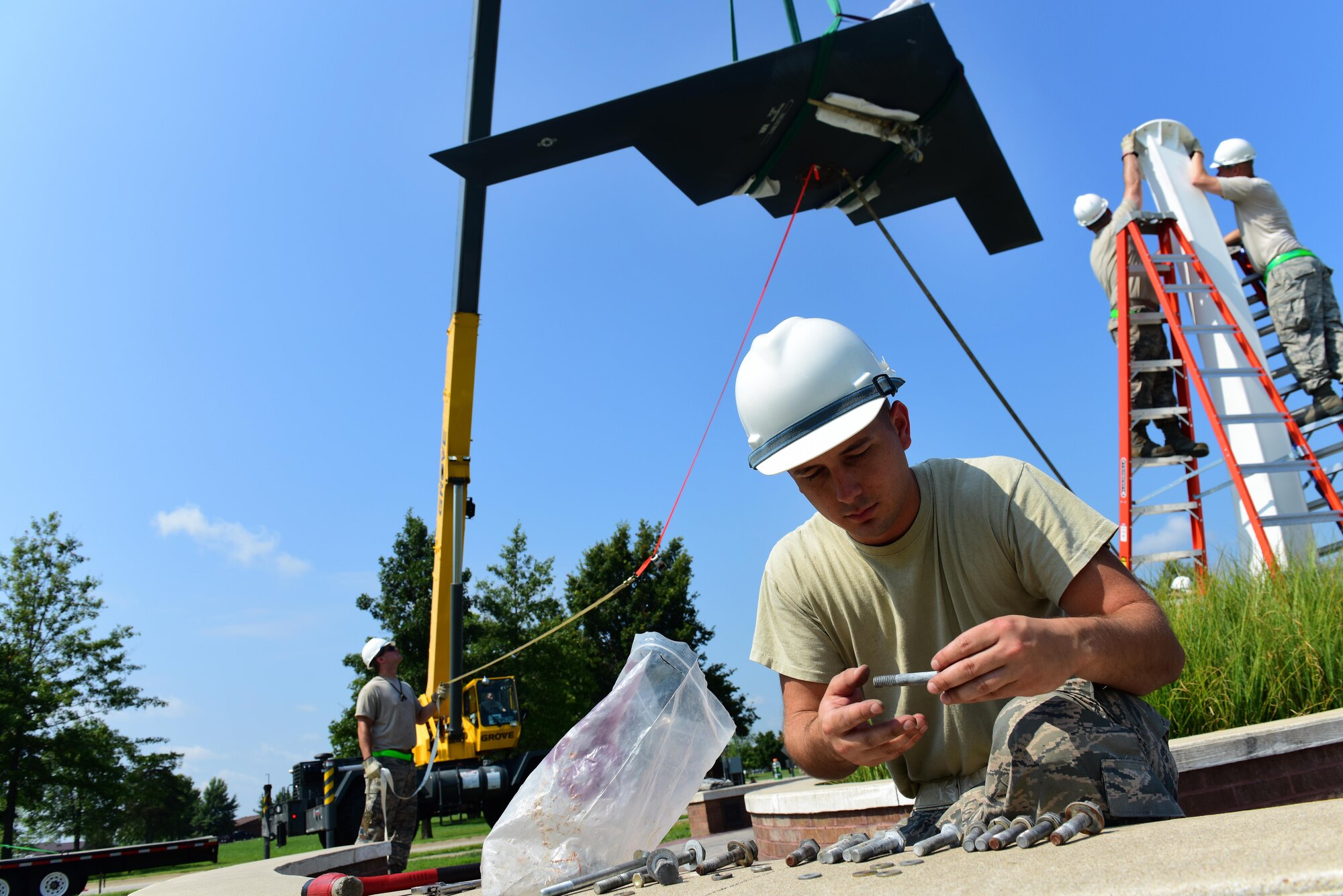 U.S. Air Force Staff Sgt. Jared Parker, a 131st Maintenance Group maintenance flight phase inspection technician, sorts bolts by size at Whiteman Air Force Base, Mo., Aug. 10, 2017. The 600-pound B-2 Spirit replica on display near the Spirit Gate, is secured by eight 5-inch bolts.