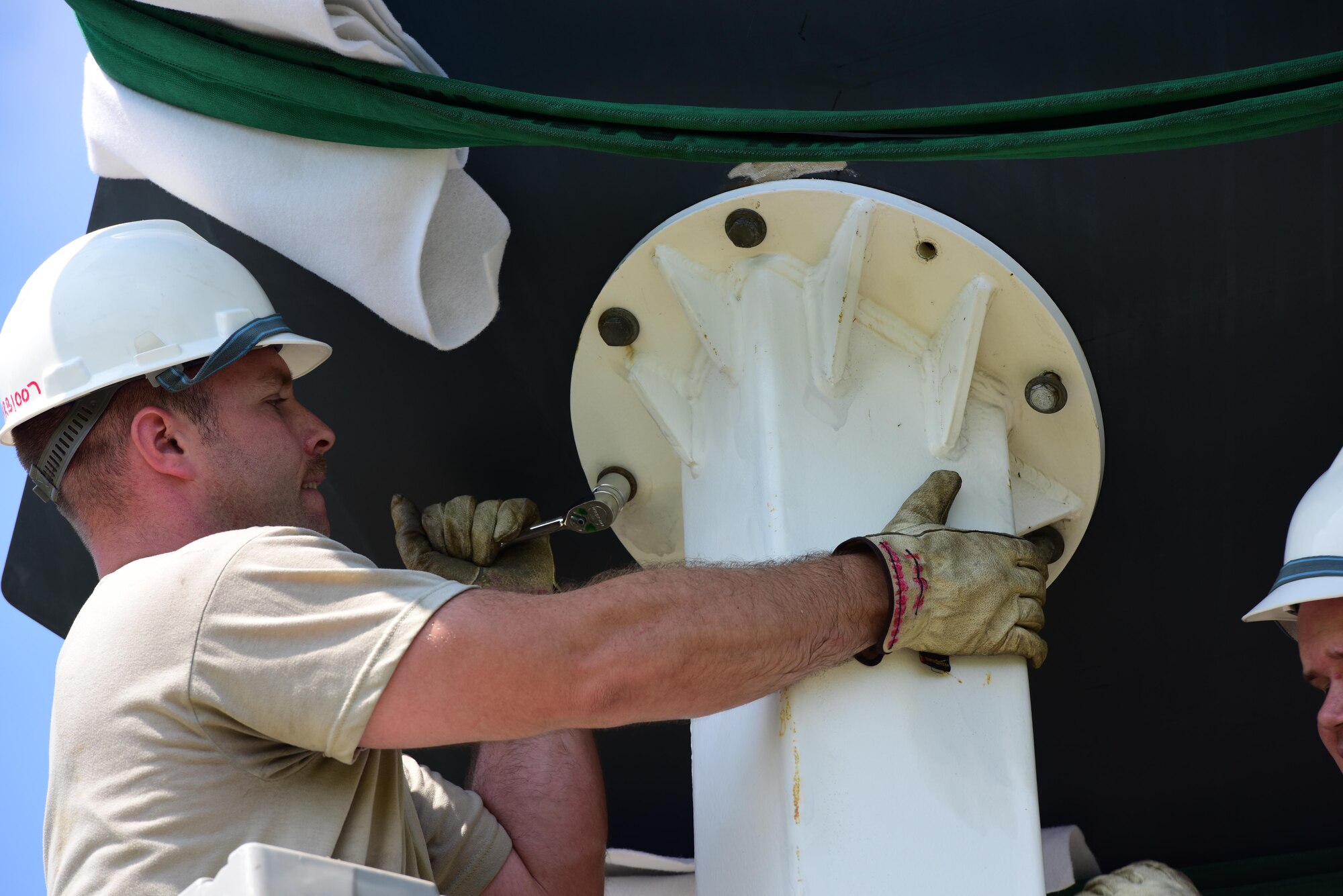 U.S. Air Force Tech. Sgt. William Conant, a 131st Maintenance Group maintenance flight phase technician, tightens down a bolt to hold the B-2 Spirit replica into place at Whiteman Air Force Base, Mo., Aug. 10, 2017. The aerospace repair and phase inspection shops led the project of replacing the static after the old display was removed for repairs.