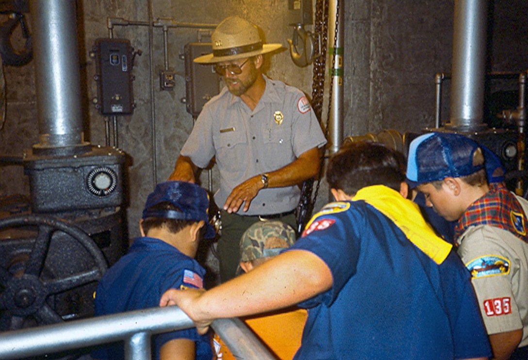 Calvin Foster takes Boy Scouts and Cub Scouts on a tour of the internal workings of the tower portion of Success Dam in 1995, when Foster was a park ranger.