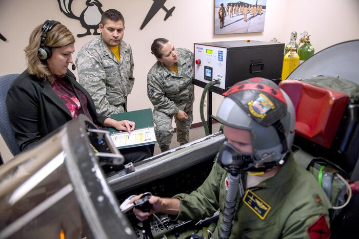 An airman uses a device that monitors vital signs.