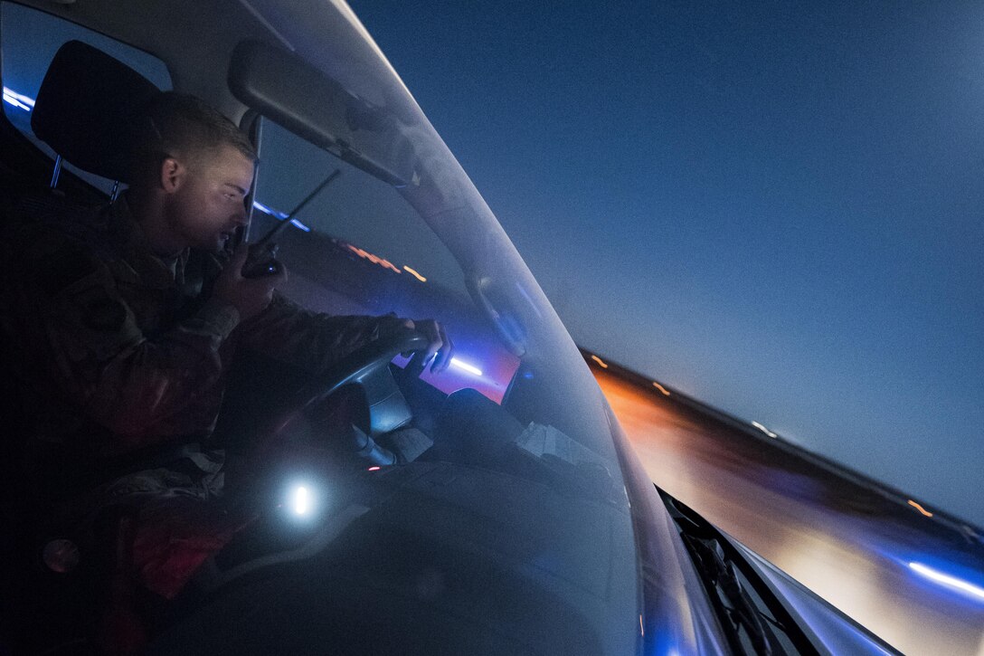 Airman 1st Class John Duggan, 332nd Expeditionary Operations Support Squadron airfield management shift lead, communicates with an air traffic controller as he inspects a runway for potential hazards August 4, 2017, in Southwest Asia. People, vehicles and animals on a flightline all pose a potential danger to aircraft. (U.S. Air Force photo/Senior Airman Damon Kasberg)