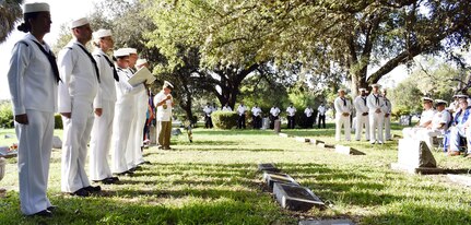 Petty Officer 1st Class Adria Dowden (center with notebook), a Hospital Corps School laboratory technician instructor and CPO select, reads Seaman John E. “Jackie” Kilmer's bio during an Aug. 15 graveside memorial service in San Antonio honoring Kilmer, who was posthumously awarded the Medal of Honor June 18, 1953.