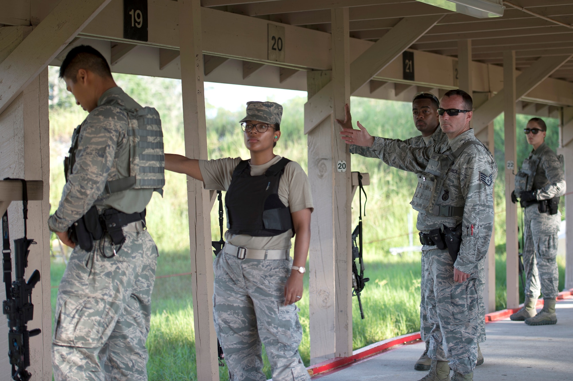 U.S. Air Force security forces members assigned to the 6th Security Forces Squadron at MacDill Air Force Base, Fla., signal to the lead instructor that the line is safe and clear during a proficiency fire training, Aug. 16, 2017.