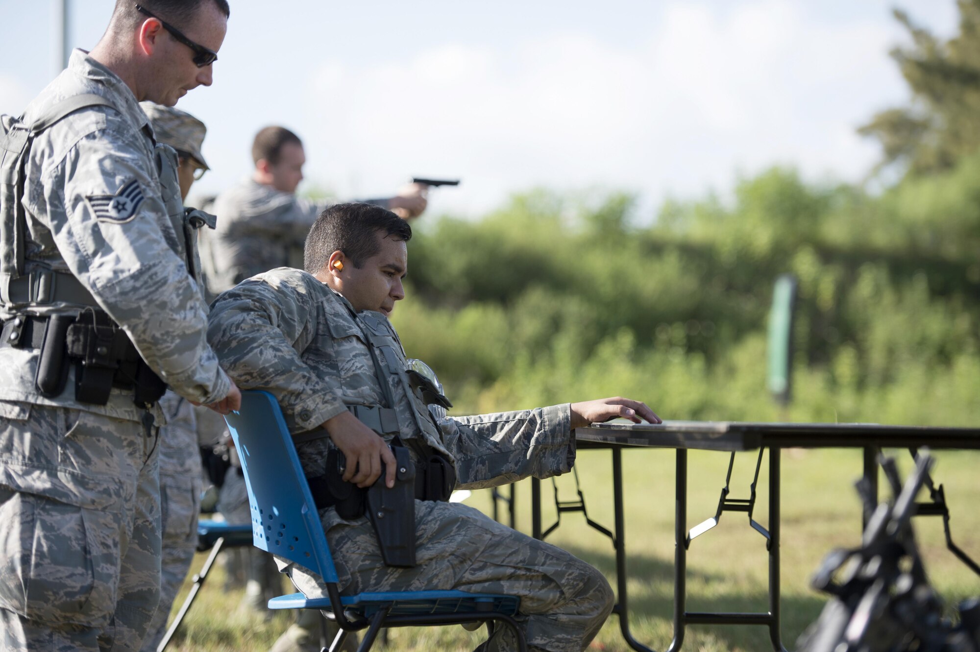 U.S. Air Force security forces members assigned to the 6th Security Forces Squadron practice firing at a threat from a desk, Aug. 16, 2017 at MacDill Air Force Base, Fla.