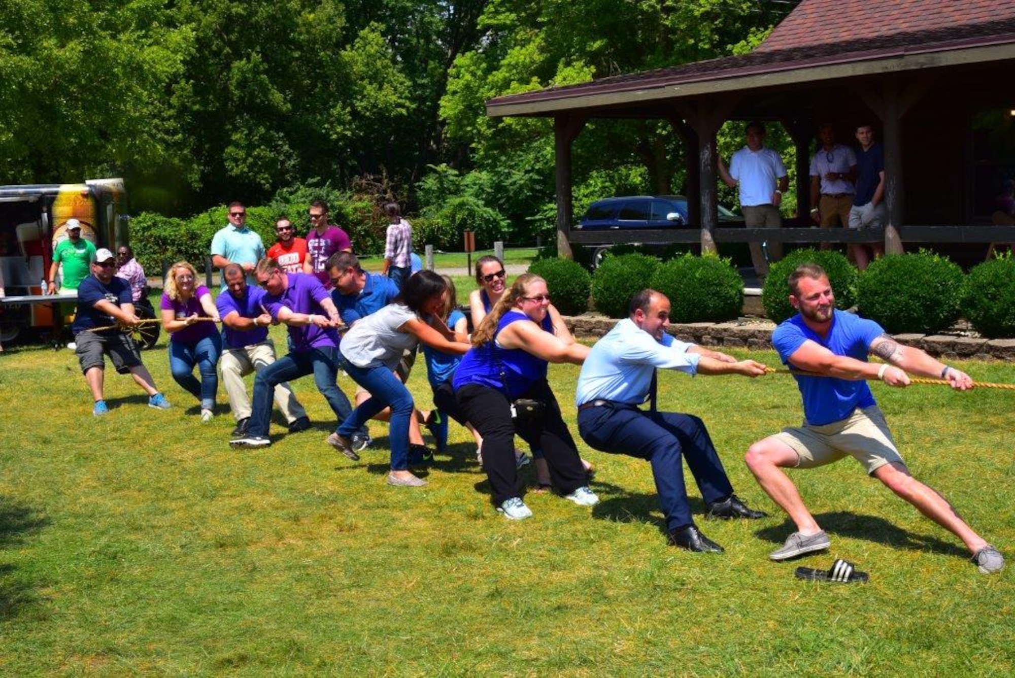 Financial management and contracting interns battle it out with program management interns in a friendly challenge of tug of war at the inaugural Wright-Patterson Air Force Base picnic held at Bass Lake Aug. 10.The PM interns were victorious. (U.S. Air Force photo/Alex Feuling)
