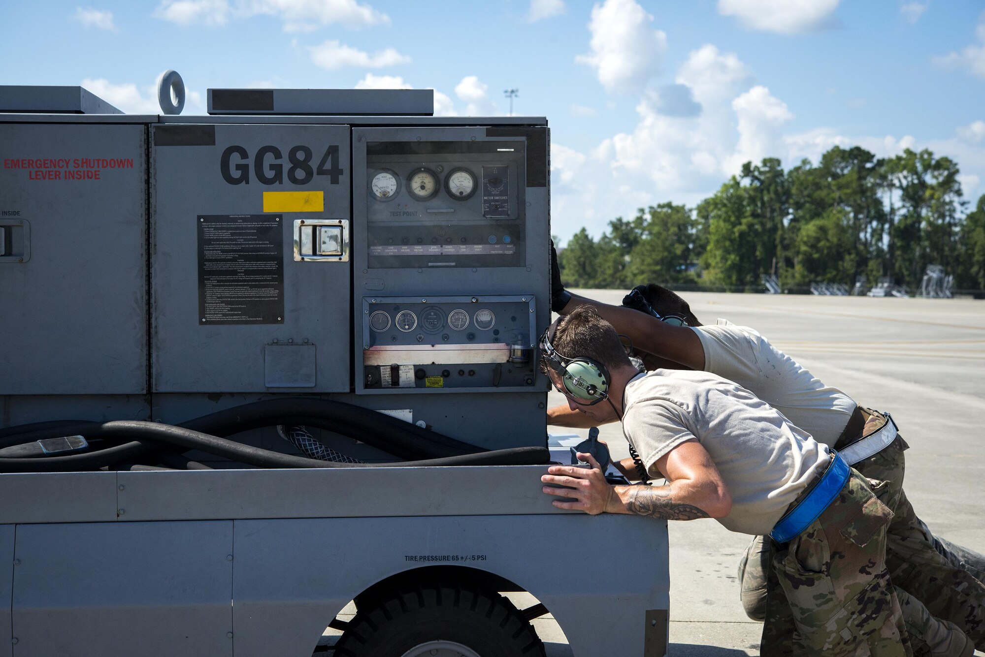 Airmen from the 71st Rescue Squadron Aircraft Maintenance Unit clear a power unit off the flight line prior to launching a HC-130J Combat King II before it takes off, Aug. 17, 2017, at Moody Air Force Base, Ga. Maintainers perform various tasks prior to take-off such as pre-flight inspections, removing plugs and covers, repairing any problems found during crew pre-flight checks and marshalling the aircraft. (U.S. Air Force photo by Airman 1st Class Erick Requadt)