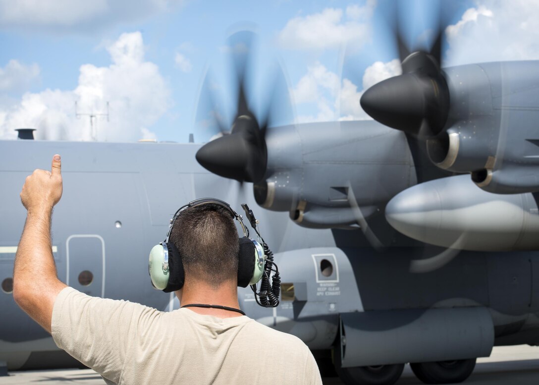 An Airman from the 71st Rescue Squadron Aircraft Maintenance Unit marshals a HC-130J Combat King II, Aug. 17, 2017, at Moody Air Force Base, Ga. Maintainers perform various tasks prior to take-off such as pre-flight inspections, removing plugs and covers, repairing any problems found during crew pre-flight checks and marshalling the aircraft. (U.S. Air Force photo by Airman 1st Class Erick Requadt)