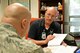 Robert Snyder, Recovery Care Coordinator for the Pacific Northwest region, consults a member of the Air Force Wounded Warrior Program Aug. 15, 2017, at Fairchild Air Force Base, Washington. This program is a congressionally-mandated, federally-funded program providing personalized care, services and advocacy to seriously wounded, ill or injured service members, their caregivers or families. (U.S. Air Force photo by Airman 1st Class Jesenia Landaverde)