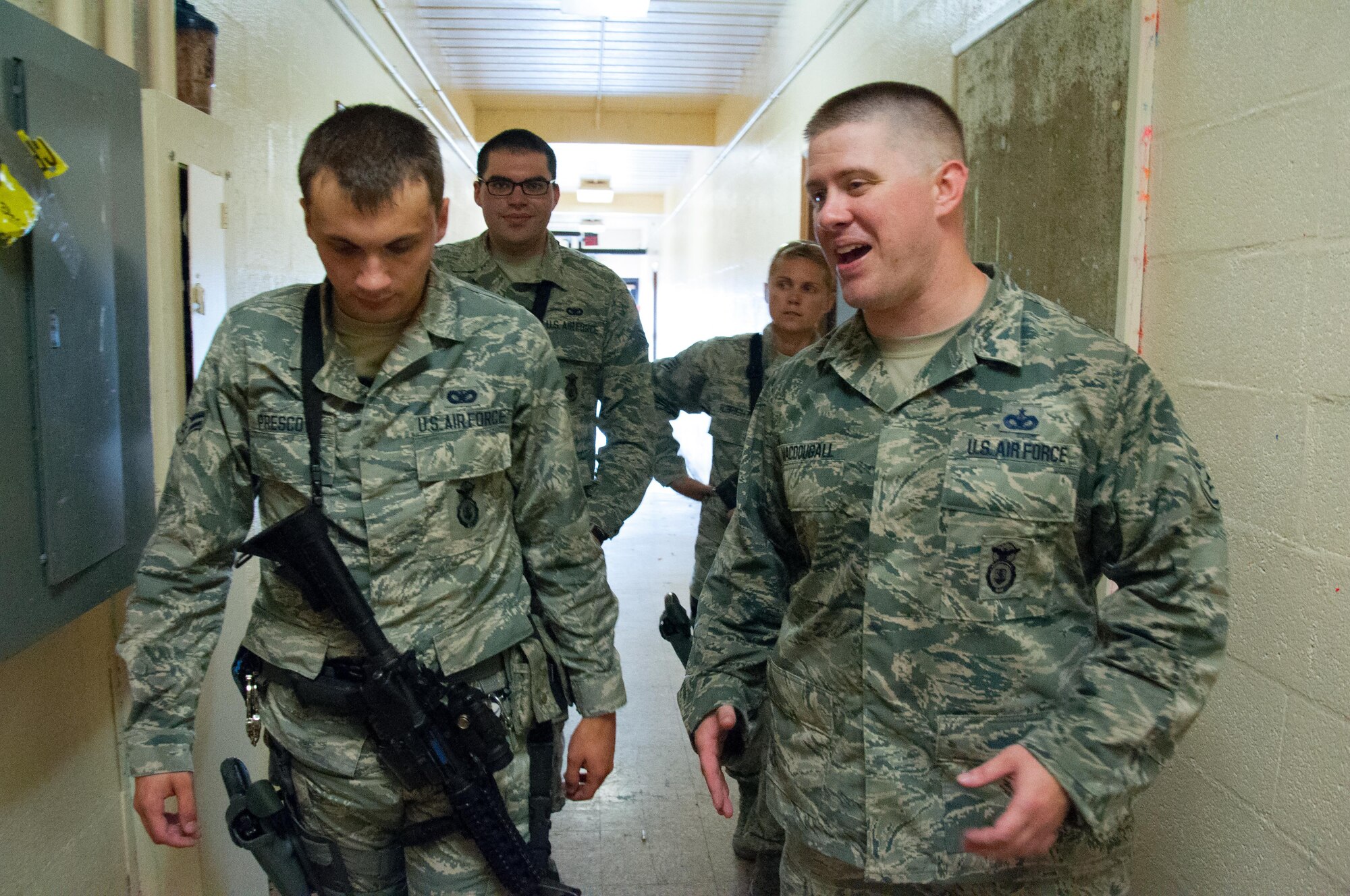 DAYTON, Ohio – Staff Sgt. Malcolm MacDougall, 88th Security Forces Squadron unit instructor (right), debriefs 88 SFS defenders on their performance after completing a room clearing walkthrough during annual training July 12. Students first complete walkthroughs of exercises before conducting live-fire demonstrations with simulation rounds. (U.S. Air Force photo/John Harrington)