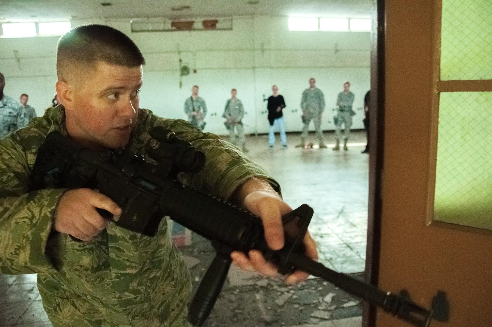 DAYTON, Ohio – Staff Sgt. Malcolm MacDougall, 88th Security Forces Squadron unit instructor, demonstrates the correct way to enter a room during clearing operations to 88 SFS defenders during annual training July 12. MacDougall instructs the week-long course two to three times a month to classes that average 12 to 15 students. (U.S. Air Force photo/John Harrington)