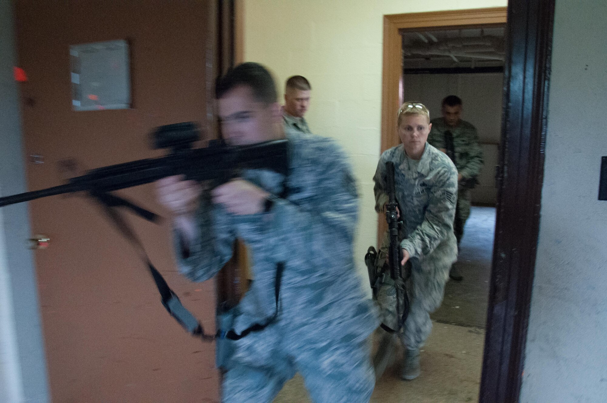 DAYTON, Ohio – Staff Sgt. Kyle Brophy (left), 88th Security Forces Squadron investigator, enters a room first during a walkthrough prior to conducting clearing exercises with Staff Sgt. Heather Albright, 88 SFS canine handler, entering behind him during annual training July 12. Defenders from throughout 88 SFS learn to work together in executing security missions in the week-long course. (U.S. Air Force photo/John Harrington)
