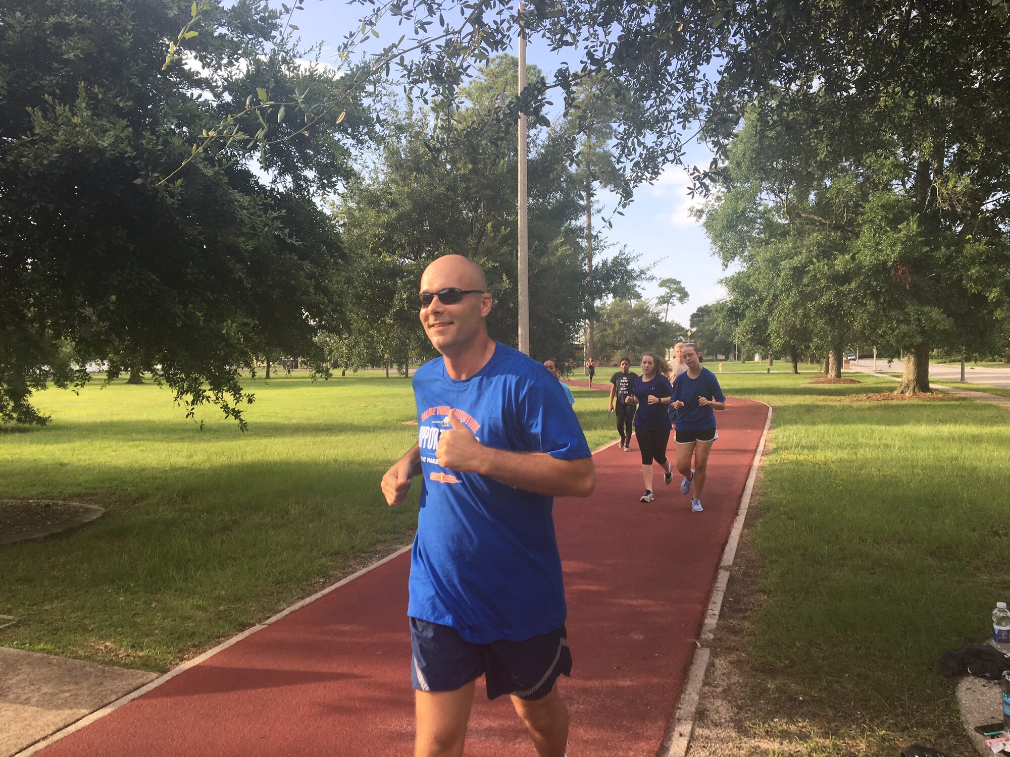 Master Sgt. Travis Rhoades, 403rd Wing recruiter, runs with members of the Developmental and Training Flight at Keesler Air Force Base, Mississippi. (U.S. Air Force photo