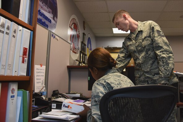 U.S. Air Force Tech. Sgt. Matthew Watts, 17th Medical Support Squadron medical material technician, takes an opportunity to help train Airman Khrystian Anderson, 17th MDSS medical material apprentice, in the Ross Clinic at Goodfellow Air Force Base, Texas, Aug. 16, 2017. The member spotlight went to Watts for his outstanding work ethic and willingness to step up and take on more responsibilities due to a shrinking office.