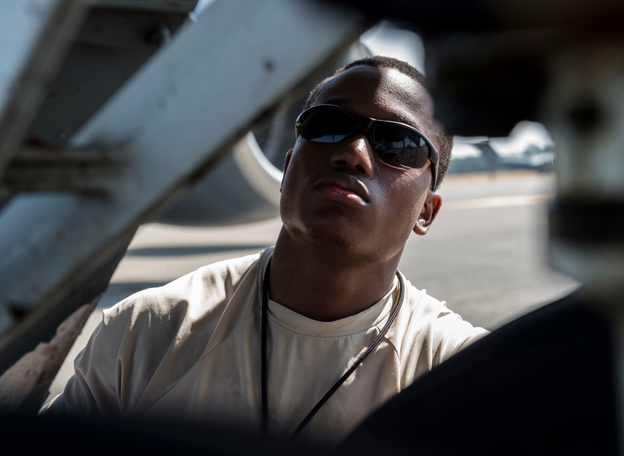 A maintainer inspecting an aircraft