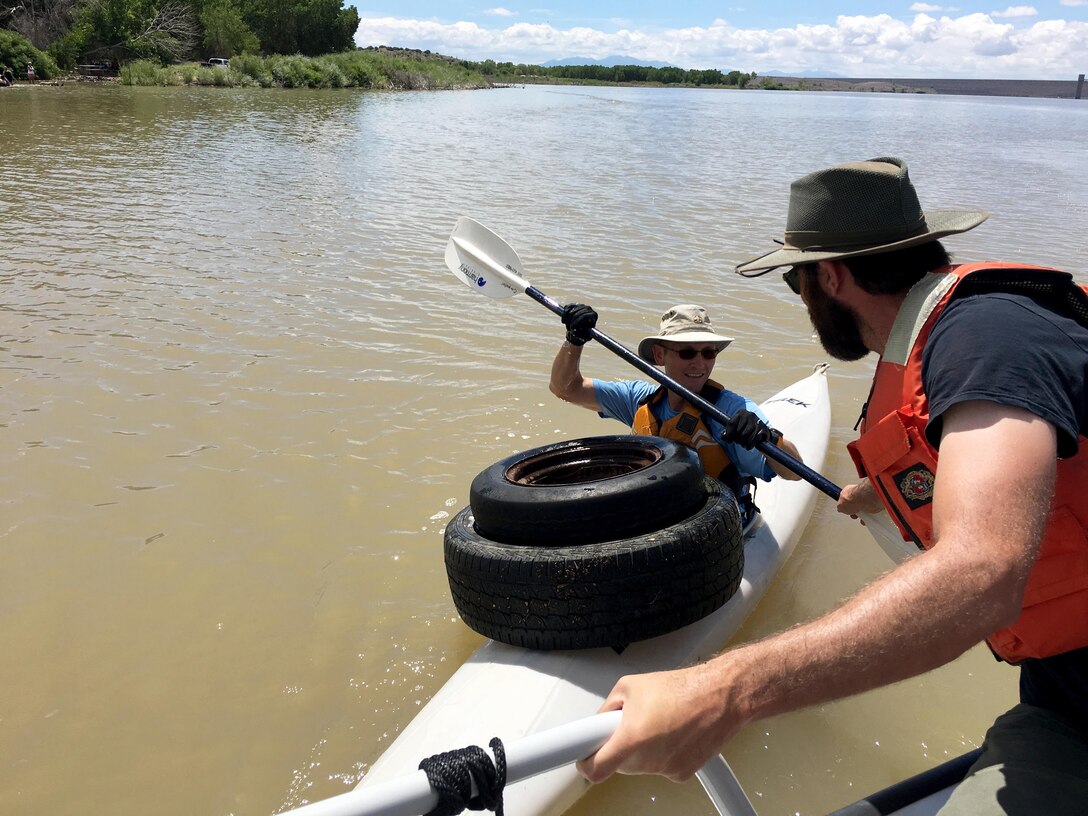 COCHITI LAKE, N.M. – A volunteer drops off two tires during the “Cochiti Sweep” event, Aug. 12, 2017.