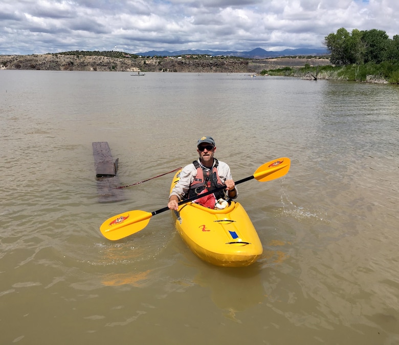 COCHITI LAKE, N.M. – Many of the volunteers were in kayaks with limited carrying capacity and thus came up with creative ways to haul trash. This volunteer tied rope around discarded lumber debris to bring it in.