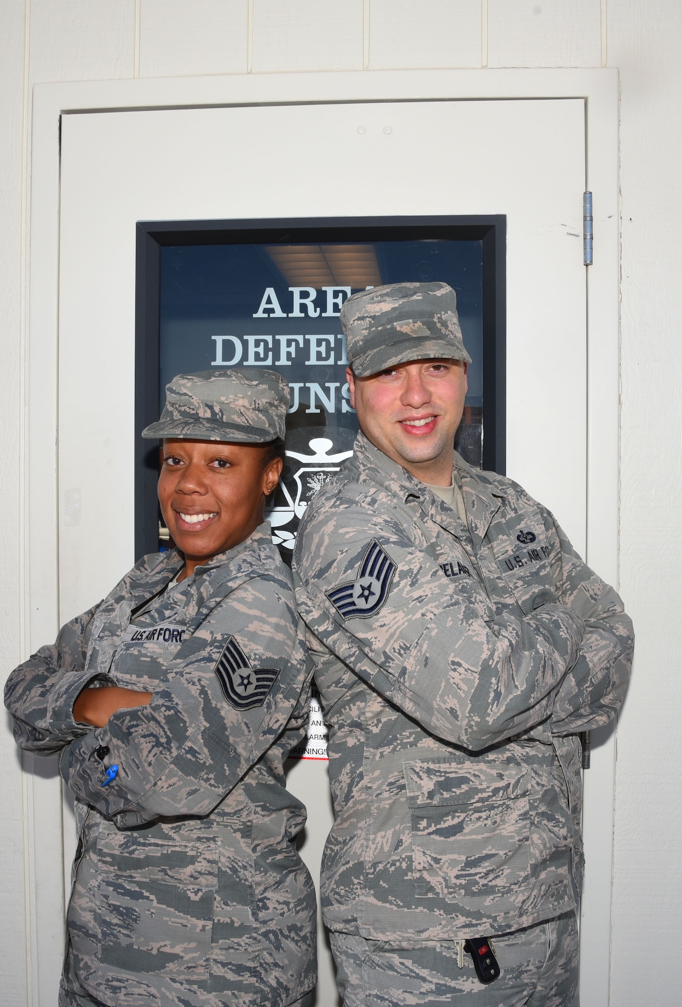 Tech. Sgt. Breyon Davis, 582nd Operations Support Squadron NCO in charge of current operations, and Staff Sgt. Joshua Belanger, Air Force defense paralegal, stand together in front of the Area Defense Counsel building at F. E. Warren Air Force Base, Wyo., Aug. 18, 2017.