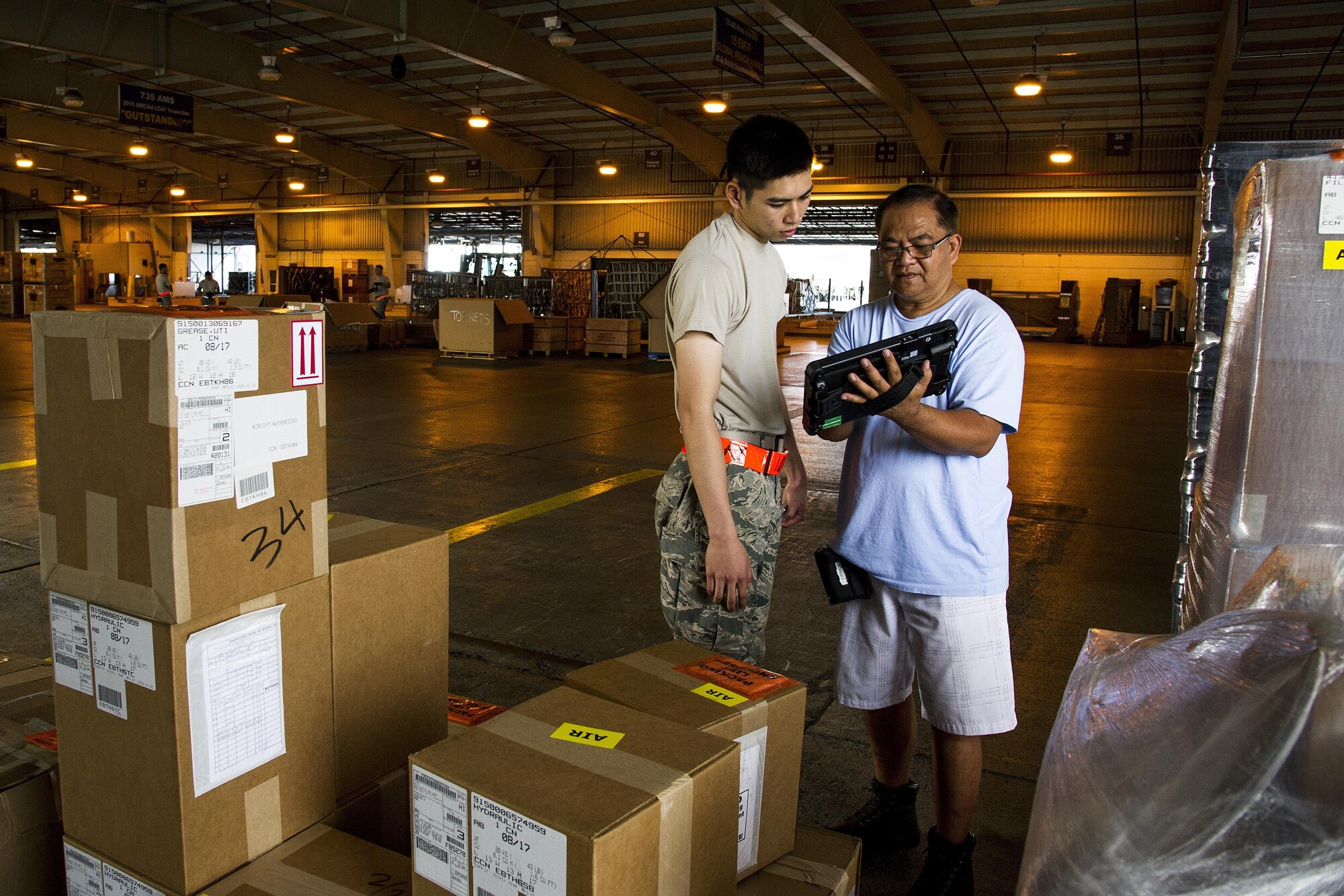 U.S. Air Force Airmen Allan Lai, of Honolulu, an air transportation specialist for the Air Force Reserve’s 48th Aerial Port Squadron, learns how to take inventory of the cargo from Nathan Guiao, a former member of the 48th APS, at Joint Base Pearl Harbor-Hickam, Hawaii, Aug. 17, 2017. The 48th APS provides expertise in all areas of air terminal operations to include aircraft loading, cargo processing and inspecting, passenger services, aircraft fleet services and aerial port command and control.