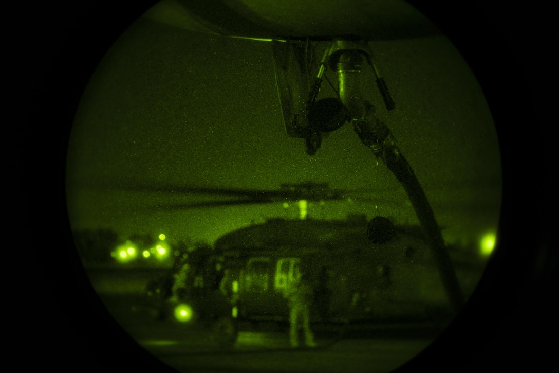 A hose pumps fuel from a U.S. Marine Corps KC-130J Hercules with Marine Aerial Refueler Transport Squadron (VMGR) 152, to a U.S. Army MH-60 Black Hawk helicopter with the 4-160th Special Operations Aviation Regiment (SOAR), while conducting air delivered ground refueling during unit-level training Evergreen in Salem, Oregon, August 17, 2017. VMGR-152 aircrew Marines deployed a mobile gas station for rotary wing aircraft, running hoses from the KC-130J in a tactical manner, which allowed aircraft to taxi in, receive fuel and continue on their way with no delay. (U.S. Marine Corps photo by Cpl. Joseph Abrego)