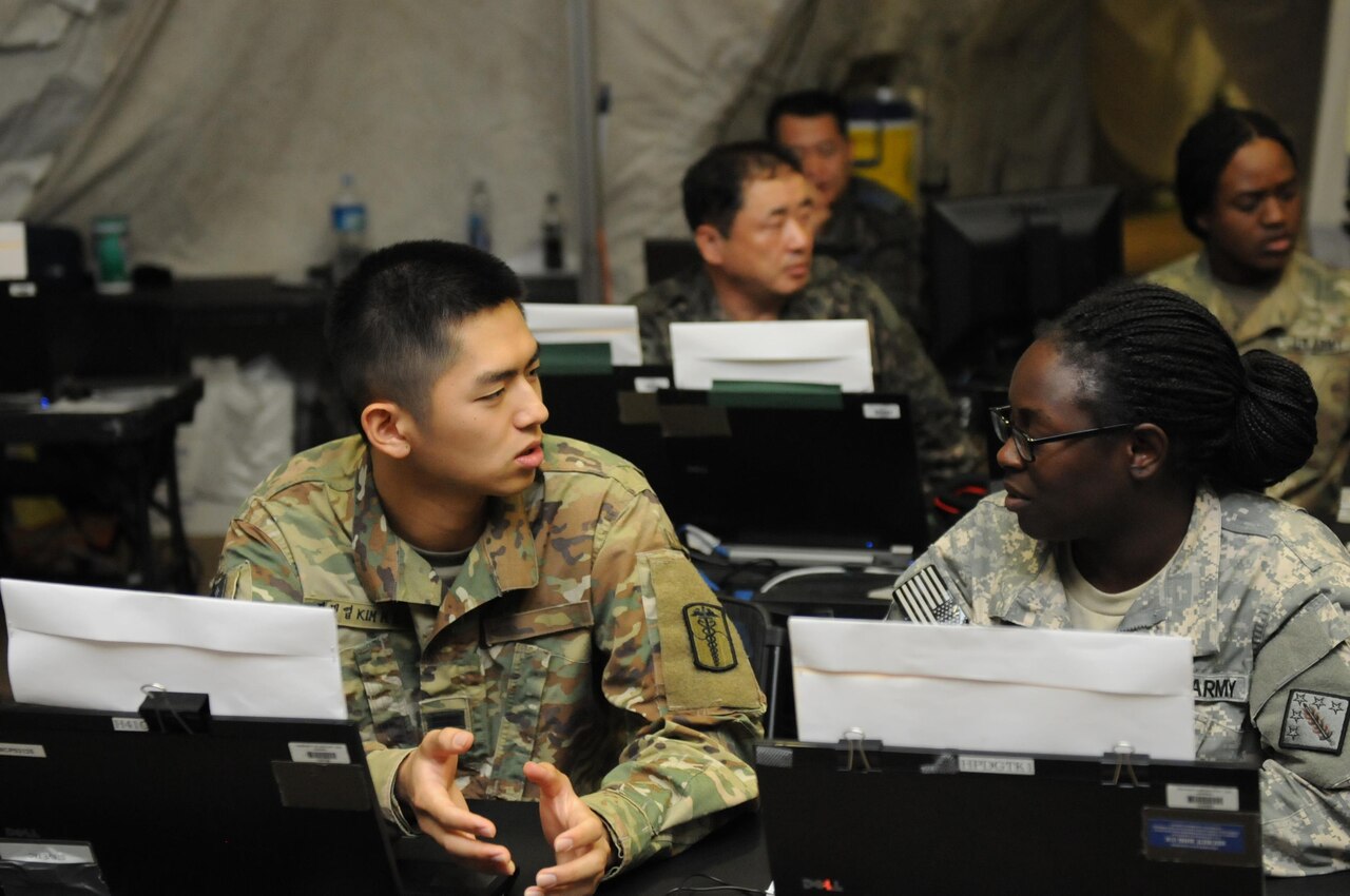 South Korean and U.S. soldiers at computer station.