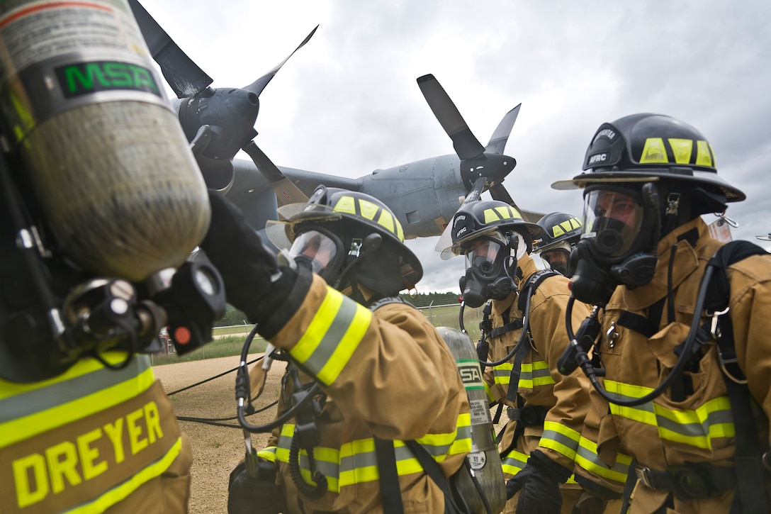 Air Force airmen respond to a C-130 Hercules aircraft crash training scenario.