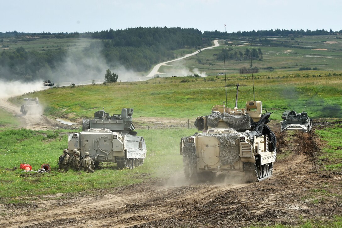 M1A1 Abrams tanks and Bradley fighting vehicles participate in a combined arms live-fire exercise